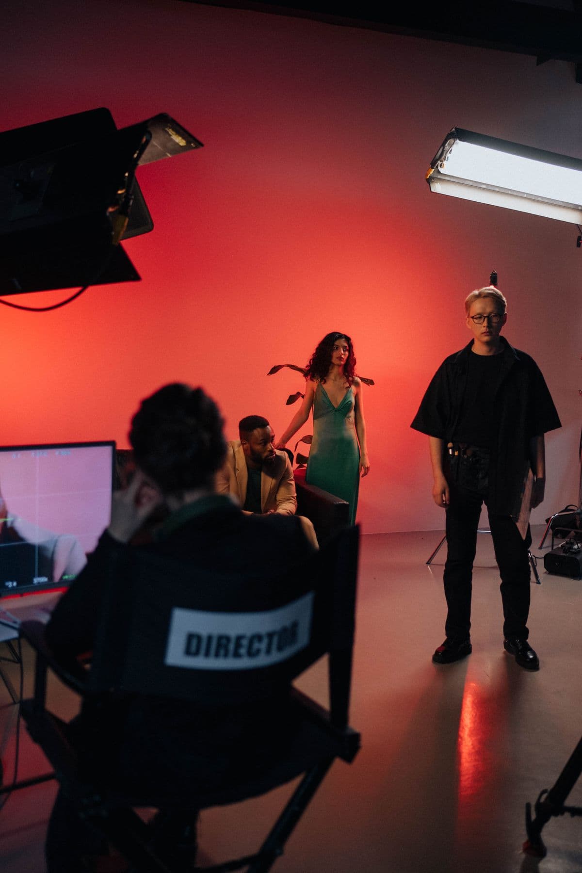 A director sitting on a chair on a film studio set