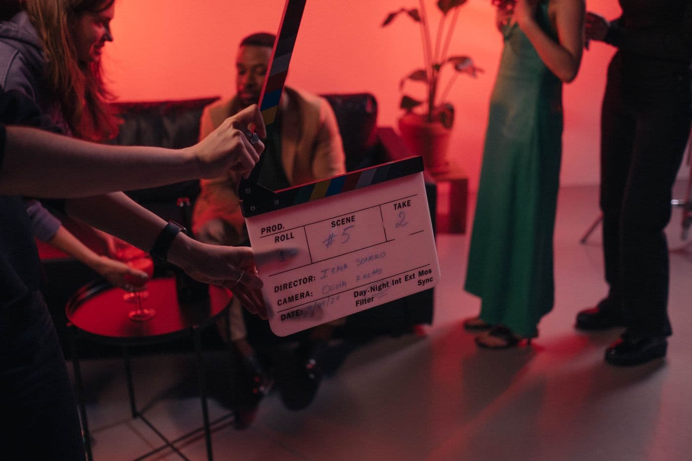 Crew member holding a clapperboard on a film set