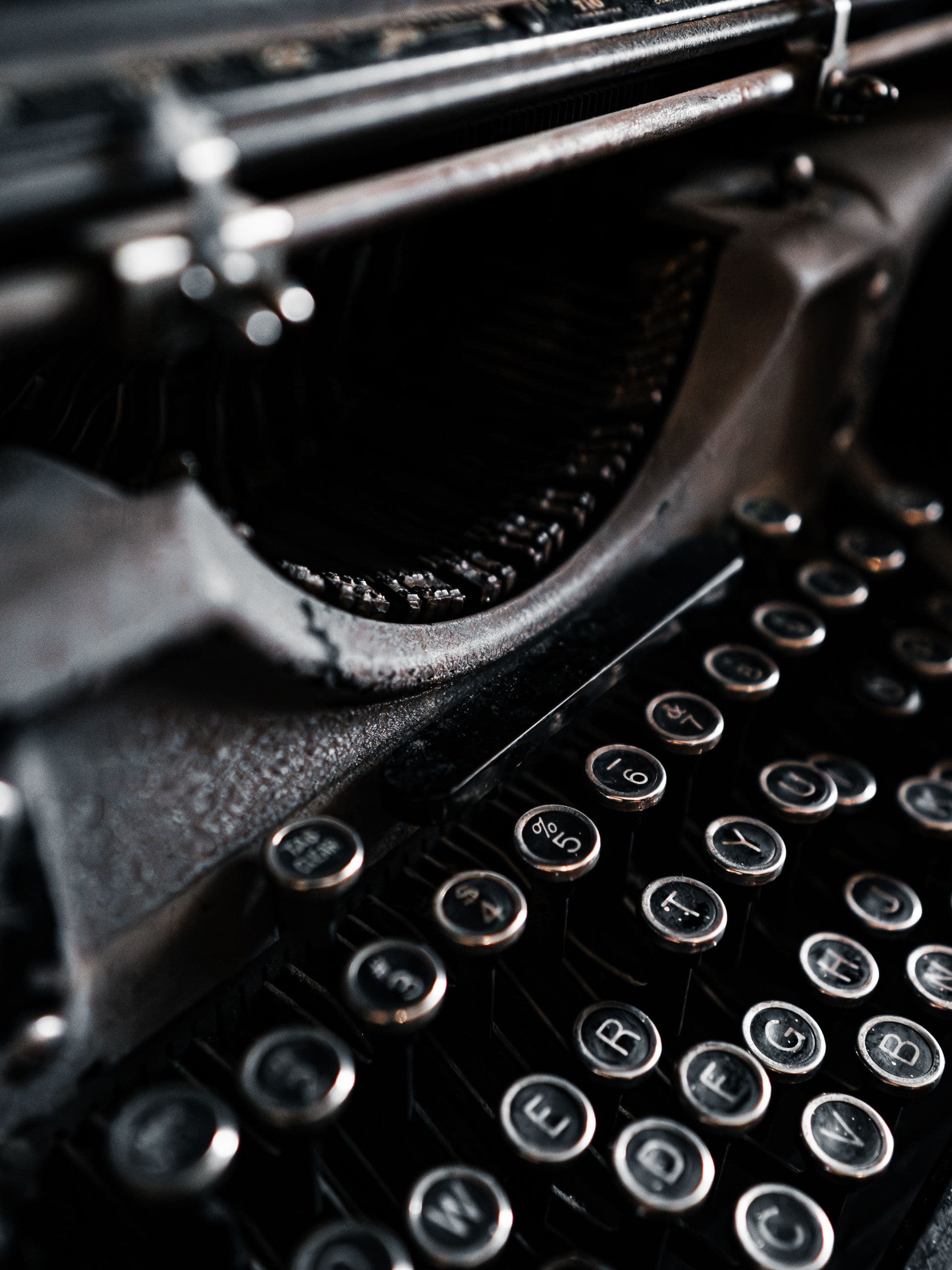 Dramatic close-up of a vintage typewriter's keys and carriage
